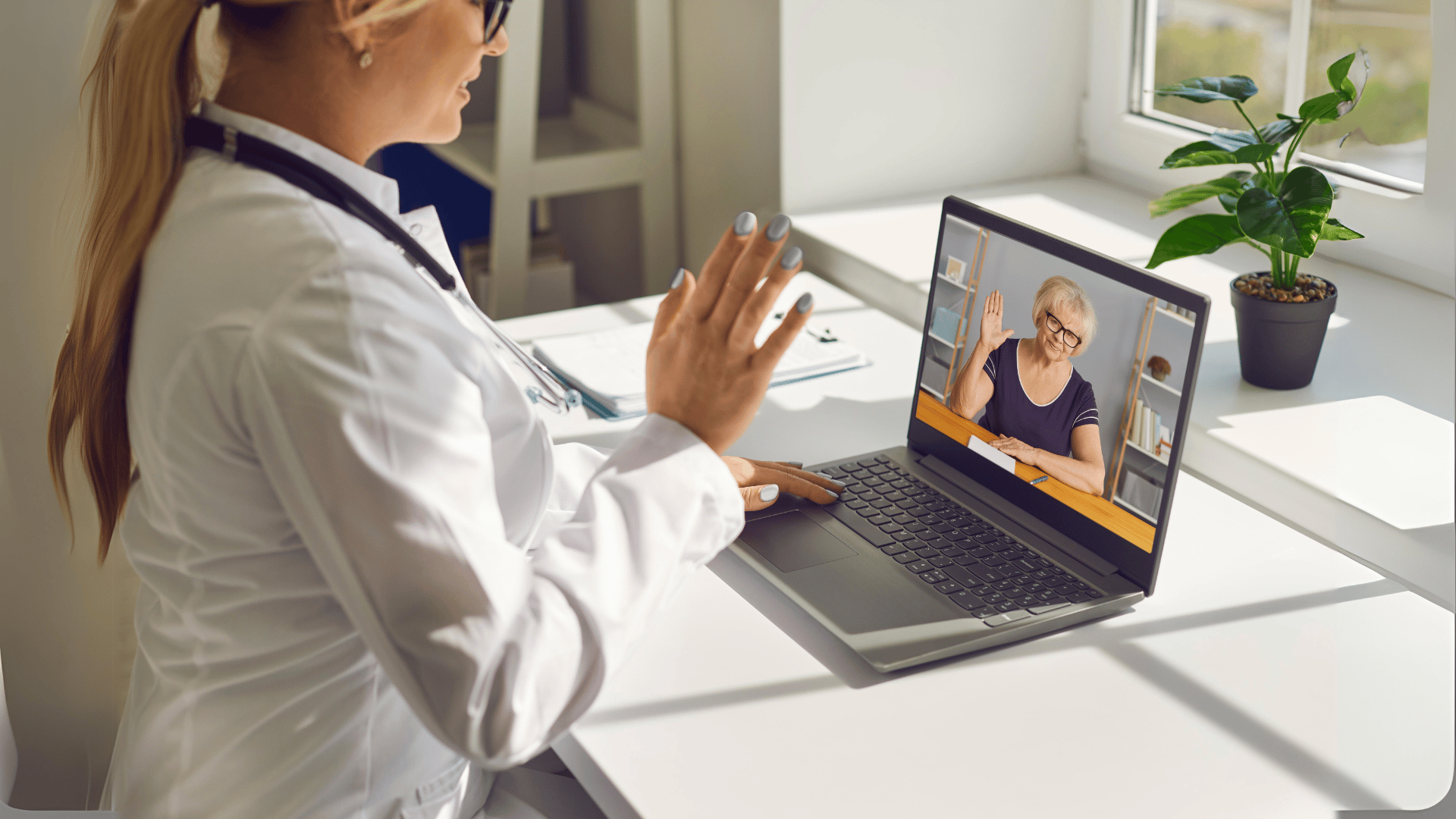 a woman in a white coat and stethoscope talking to a doctor on a laptop